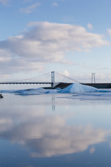Fototapeta premium Reflcetion ligth over the lake with bridge crossing, Iceland winter season natural landscape background