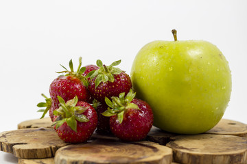 Strawberry and apple on a white background