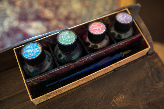 Antike Tintenfässer in verschiedenen Farben, und  Schreibfeder