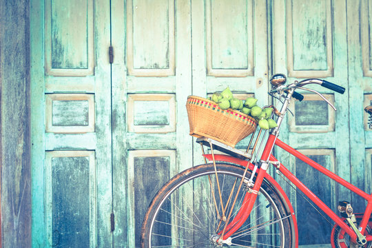 Hipster red bicycle in old building walls background , color if vintage tone  - Powered by Adobe