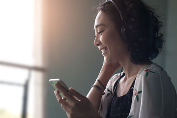 young beautiful asian woman girl in casual wear relaxing and listening music headphones indoor