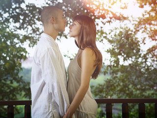 Fototapeta premium Man and woman holding hands while looking at each other