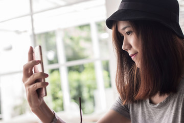 young hipster woman making selfie by her smart phone, urban life concept. .