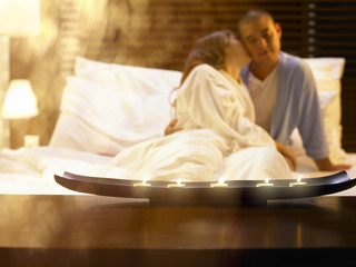 Man and woman embracing in bed