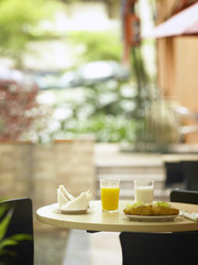 croissant, sandwich, orange juice and milk on the table