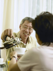 husband serving coffee for wife