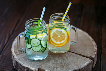 Refreshing drink from lemon, cucumber, orange and peppermint. Detox water. Top view. The concept of...