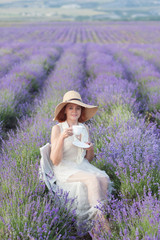 Portrait of Beautiful 50 Years old Woman Drinking Tea Outdoors in Lavender