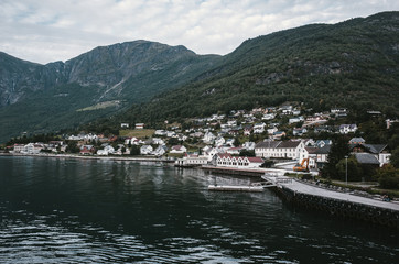 Sailing through Sognefjord, Norway. Picturesque small village on the way to Flam