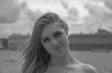 a beautiful girl walks by the river, black and white.