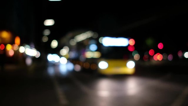 city traffic at night - bus and cars bokeh lights on street 