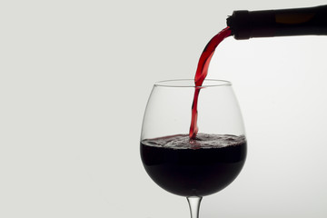 Red wine poured into a glass