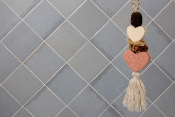 beautiful decorative soap in the shape of a heart on the background tiles in the bathroom