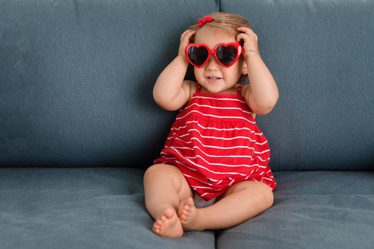 Toddler wearing heart shaped sunglasses