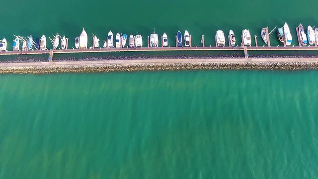 Aerial shot sea and yatch club by the water camera down in a sunny day