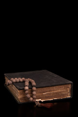 Old book and church rosary