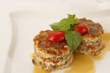 Moussaka arranged on a plate, Traditional dish in elegant setting, Selective focus with soft light
