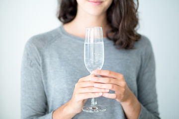 Close-up of woman holding champagne flute © Mangostar