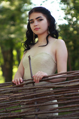 girl near a wicker fence