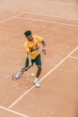 A young man beats off a ball with a tennis racket. A tennis player holds a duel on a tennis court.