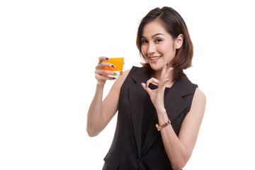 Young Asian woman show OK drink orange juice.