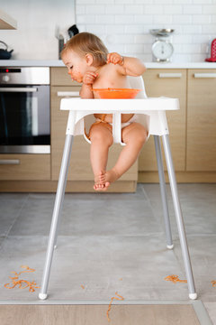 Toddler In High Chair Paking A Mess With Pasta