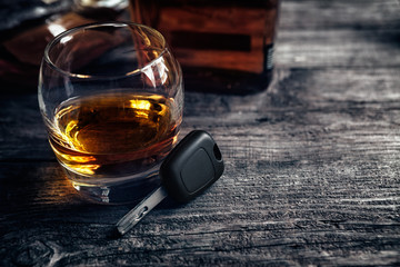 Driver keys and glass of alcohol drink