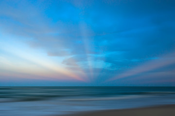 Fototapeta na wymiar Seascape with sun beams at sunset