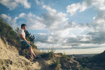 man sitting on the peak alone with his minds