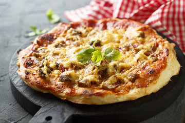 Pizza with baked meat and chili sauce