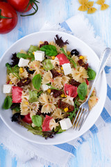 Mediterranean Farfalle salad with dry tomatoes and pine cores