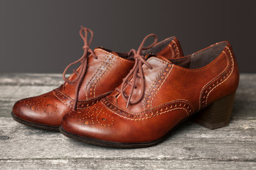 Elegant brown shoes on table