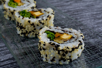 Vegan sushi on glass plate 