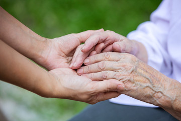 Hands of young adult and senior women
