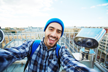 Happy tourist making selfie for vlog reportage