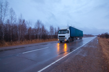 Fototapeta na wymiar White truck on a road in early morning