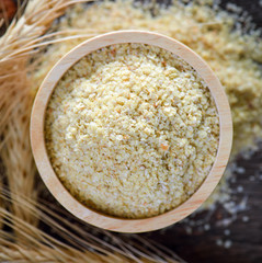 Wheat germ, the highly nutritious heart of the wheat kernel on wood table