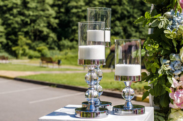 Decor candles and flowers at the wedding. Wedding ceremony.