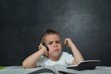 Little boy  like businessman in office with newspaper and cellphone