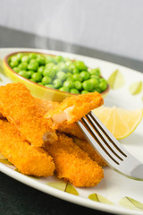 breaded fish fingers with peas, smoking hot