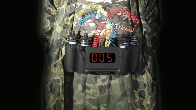 Midsection of suicide bomber with explosive belt and digital countdown timer clock