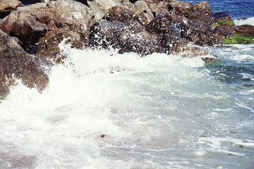 Strong sea wave crashing on the rocky shores