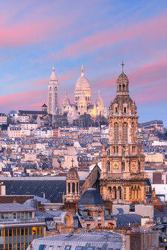 Aerial view of Sacre-Coeur Basilica or Basilica of the Sacred Heart of Jesus at the butte Montmartre and Saint Trinity church at nice sunset, Paris, France