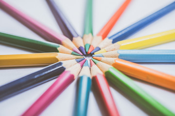 Fototapeta premium Colorful pencils in arrange in color wheel colors, warm tone