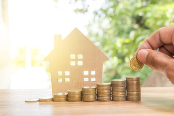 stack coins and house wood model