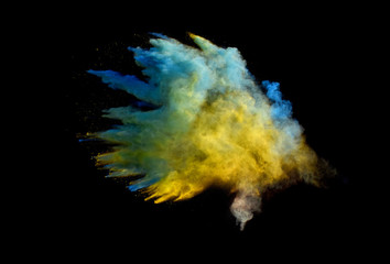 Bizarre forms of powder paint and flour combined  explode in front of a black background to give off fantastic colors and forms.