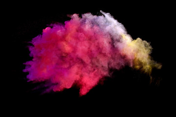 Bizarre forms of powder paint and flour combined  explode in front of a black background to give off fantastic colors and forms.