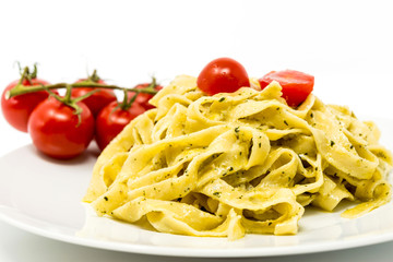 Pasta with pesto sauce and nuts on a the table