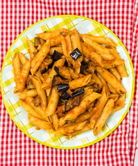 Spaghetti with aubergine and tomato on a the table