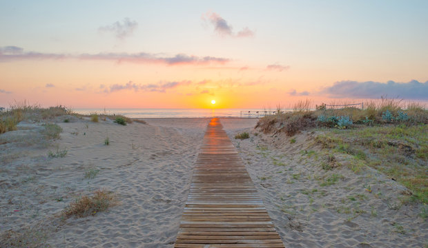 Sunrise over sea and sandy beach in spring